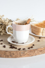 Glass cup with coffee and milk, cappuccino, served with toasted bread with butter on a light background. Simple and Portuguese breakfast.