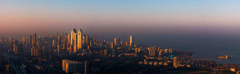 The glow of Mumbai at dawn. This is the skyline of Mumbai lit up by the first sun rays of the day.