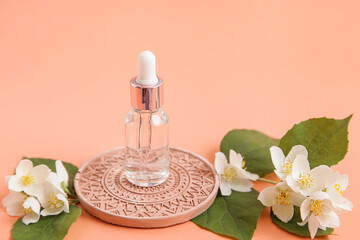 Cosmetic glass bottle for essential oils on Mandala podium background peach color Spa Natural...
