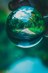 reflection with lensball, small road in the woods