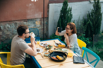 couple lunch together in home backyard