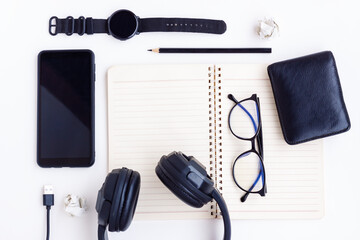 Smartphone,Smartwatch,Black Headphone,Black Wallet,Black Pencil,USB cable,Eyeglasses and Notebook on White background