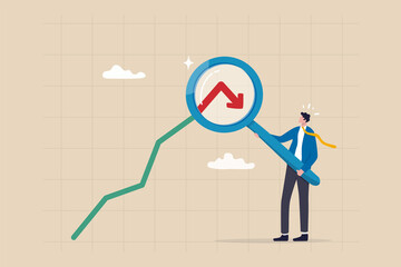 Stock market or Cryptocurrency decline, down turn or economic recession, market plunge signal, inflation or interest rate falling down concept, businessman analyst with magnifier on arrow turn down. © Nuthawut