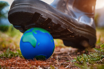 planet is under threat. The shoe presses on the layout of the planet earth.