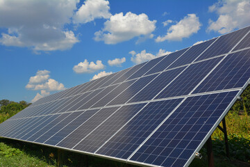 Solar panels againt blue sky and beautiful cloudscape with copy space.