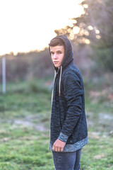 young happy boy teenager standing in front of the camera in posed portrait