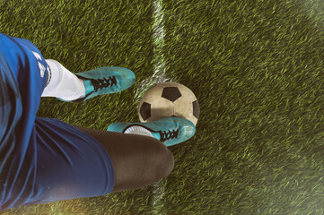 Close up of a soccer striker ready to kicks the ball at the stadium