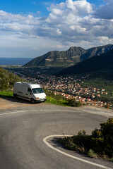 camper van on the road in mountains