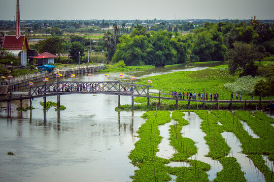Sapan Khong Floating Market,Song Phi Nong District,Suphanburi,Thailand on December 15,2018: 100 Year Arch Bridge of Thong Pradit Temple as the entrance to the market.