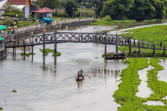 Sapan Khong Floating Market,Song Phi Nong District,Suphanburi,Thailand on December 15,2018: 100 Year Arch Bridge of Thong Pradit Temple as the entrance to the market.