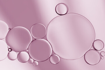 Oil and water bubbles of pink- pale purple gradient lighting effect to create an art image background.