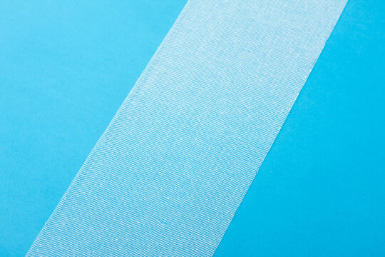 Medical sterile bandage on blue background. © Azazello
