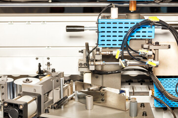 A fragment of power mechanisms with pneumatic drives of an automated machine for the production of cabinet furniture.