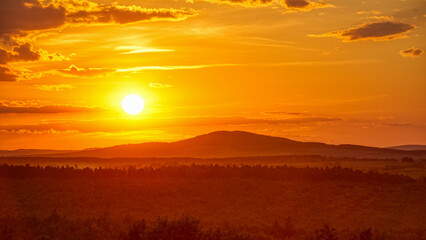 Bright sunset sky over mountain forests