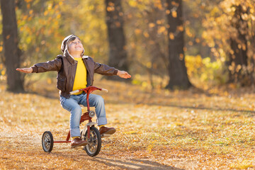 Happy child having fun outdoor in autumn park