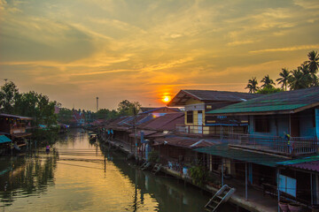 Fototapeta premium Amphawa district,Samut Songkhram Province,Thailand on April 13,2019:Sunrise in the morning at Amphawa Floating Market.