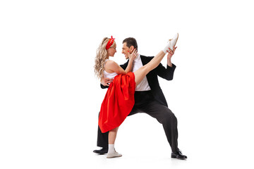 Excited young couple of dancers in vintage retro style outfits dancing social dance isolated on...