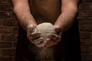 Poster White flour flying into air as pastry chef in white suit slams ball dough on white powder covered table. concept of nature, Italy, food, diet and bio © Надія Коваль