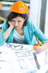 Photo of female worker with work papers at the office.