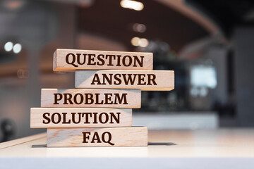 Wooden blocks with words 'question, answer, problem, solution, FAQ - frequently asked questions'. support