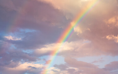 amazing bright rainbow in beautiful evening cloudy sky after rain and thunder, weather concept