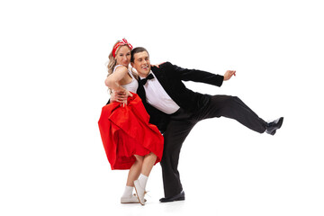 Expressive couple of dancers in vintage retro style outfits dancing social dance isolated on white background. Art, music, fashion, style concept
