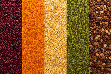 Different types of legumes, yellow peas and lentils and mung beans, red and brown beans, top view