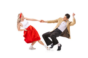 Expressive couple of dancers in vintage retro style outfits dancing social dance isolated on white background. Art, music, fashion, style concept