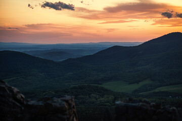 Beautiful sunset over the green hills. High quality photo.