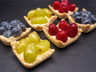 various fruit tarts on a slate