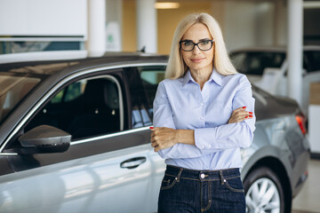 Fototapeta na wymiar Portrait of sales woman in a car showroom