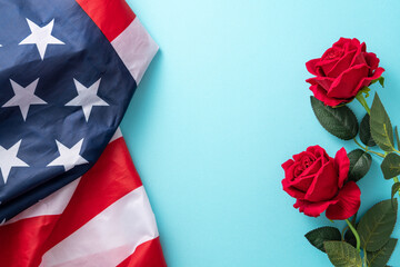 Concept of Independence day or Memorial day. American Flag over blue table background with red rose.