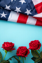 Concept of Independence day or Memorial day. American Flag over blue table background with red rose.
