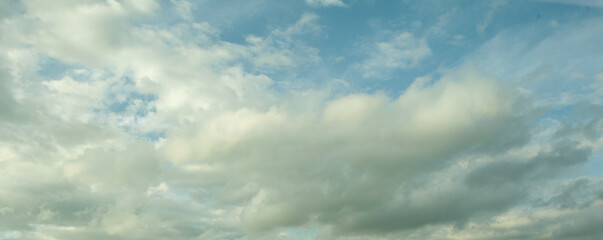 White cumulus clouds in the blue sky background