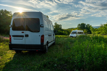 two camper parking next to lake