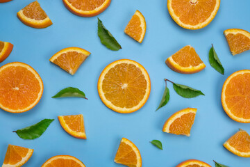 background with slides of orange and leaves on a blue background, trendy summer, fruity background