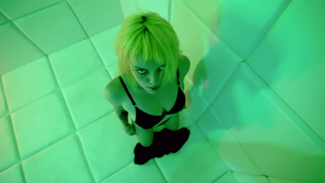 voluptuous blonde woman in black underwear is standing on knees on floor, alluring lady