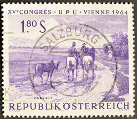 Cancelled postage stamp printed by Austria, that shows "Riders on Wet Country Lane" by J. Raffalt, U.P.U. (Universal Postal Union), 15th Congress, Vienna, circa 1964. 