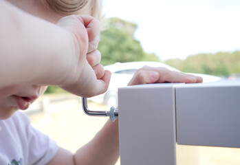 little boy tighten a bolt into white furniture close up