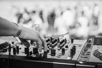 Dj mixing at beach party during summer vacation outdoor - Focus on hand - Black and white editing