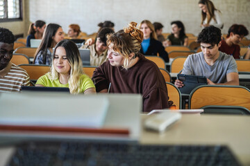 Young students working with tablets inside classroom at school university - Focus on curvy girl face