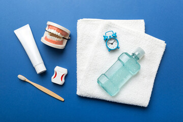 Mouthwash and other oral hygiene products on colored table top view with copy space. Flat lay. Dental hygiene. Oral care kit. Dentist concept
