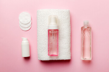Micellar cleansing water and discs to remove cosmetics and cleanse the skin on colored background. Copy space top view