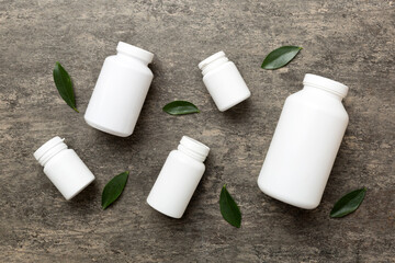 supplement pills with medicine bottle health care and medical top view. Vitamin tablets. Top view mockup bottle for pills and vitamins with green leaves, natural organic bio supplement, copy space