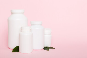 supplement pills with medicine bottle health care and medical top view. Vitamin tablets. Top view mockup bottle for pills and vitamins with green leaves, natural organic bio supplement, copy space