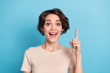 Photo of young astonished ecstatic lady find solution solve problem genius plan isolated on blue...