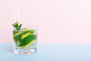 Mojito summer refreshing cocktail with ice and mint. mojito cocktail with lime, lemon and mint in a tall glass with a stick