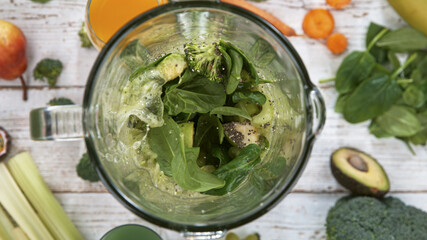 Fresh fruit and vegetables smoothie blended in blender, top view. Healthy eating concept.