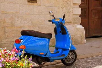 Foto op Plexiglas Retro scooter in old city of Lviv. Retro film effect. Old blue moped on street © rospoint