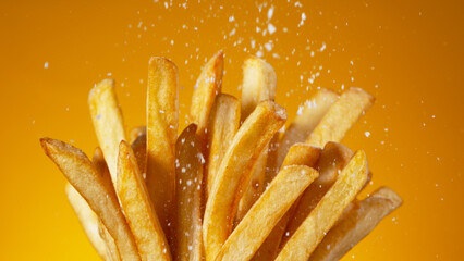 Detail Shot of adding Salt on French Fries, Close-up.